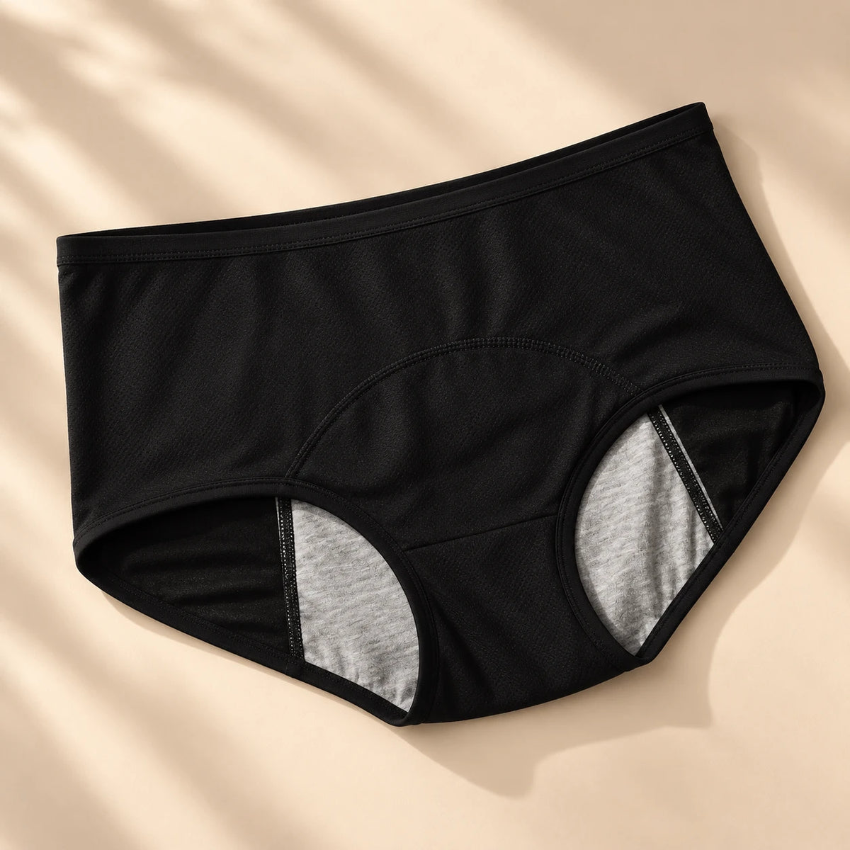 Leak-proof underwear in black, flat lay